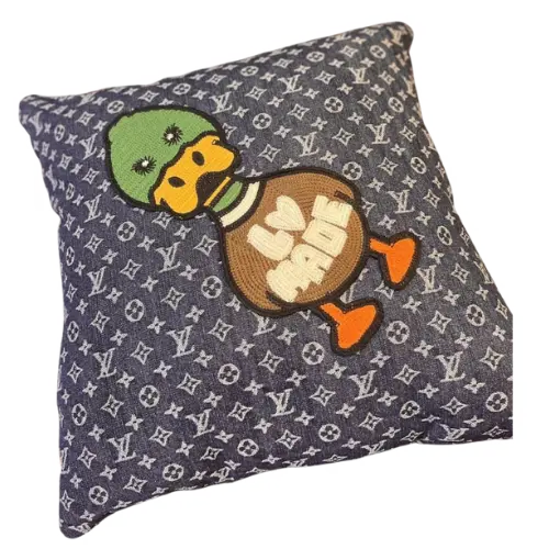 A stylish, retro‑flavored throw pillow from a streetwear brand—its blend of lettering and cartoon motifs exudes a bold, modern vibe. Paired with a cushion featuring natural-textured patterns, it effortlessly marries trendy cuteness with an air of sophistication